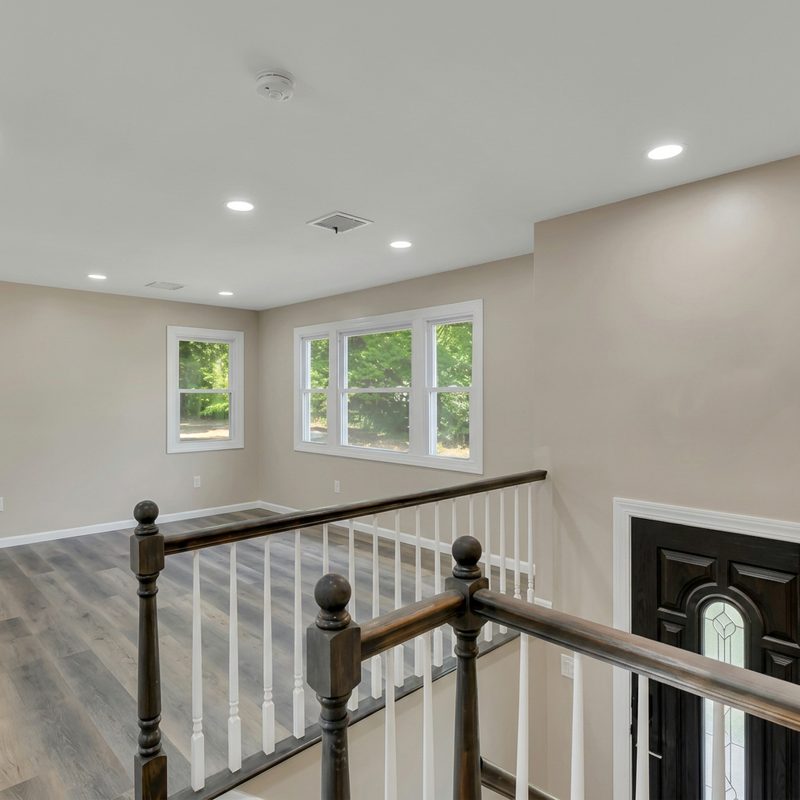Original listing photo of a stair landing and entry area